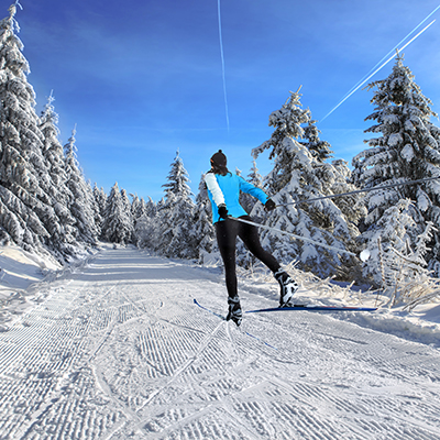 A woman cross-country skiing in the Alps