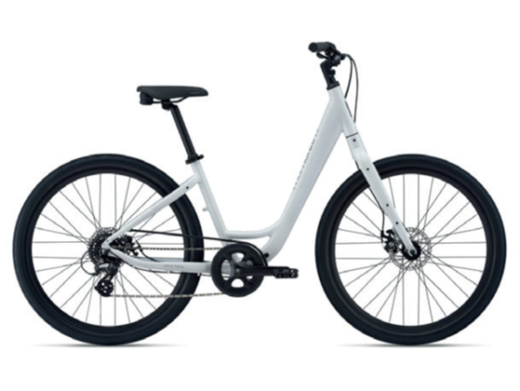 A white step-through frame bicycle with black tires, a black seat, and disc brakes, viewed from the side against a plain background.